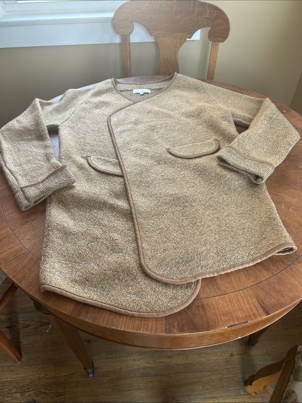 Woman’s longline sweater with wrap front and side pockets! New
